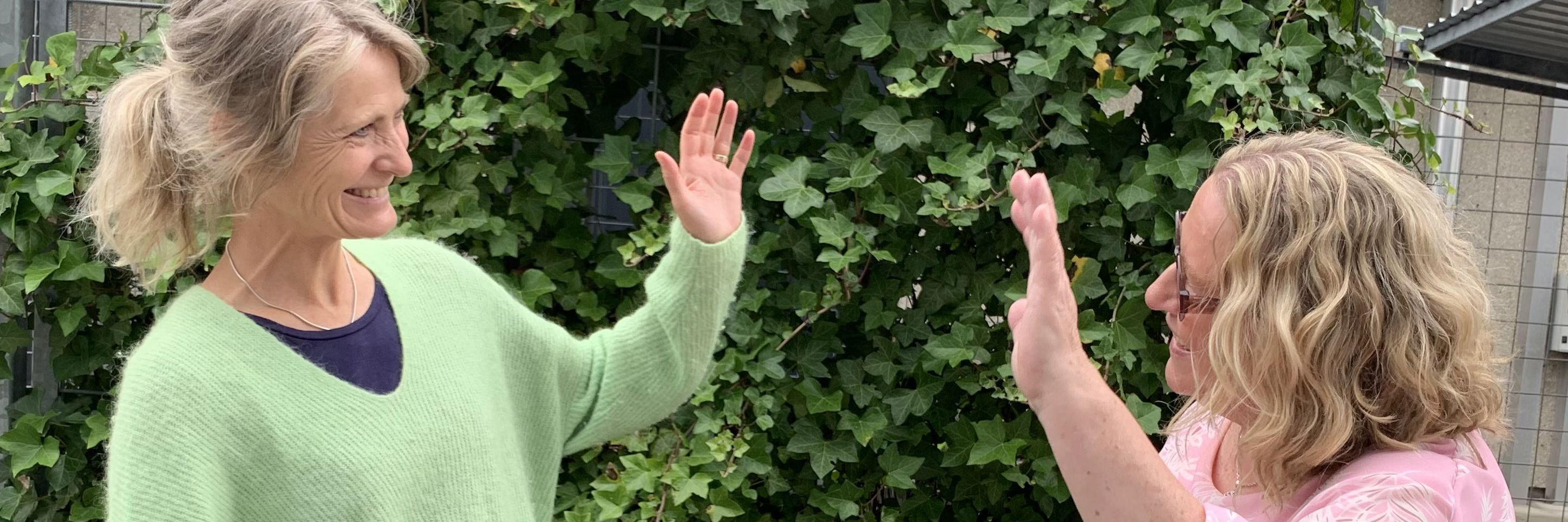 To kvinder der hilser på hinanden